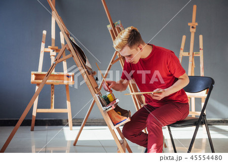 artist painting a picture in a studio 45554480