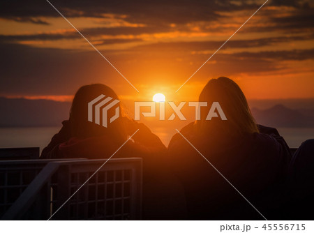 Rear view of Traveler couple woman looking sea  45556715