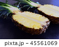 Halves of pineapple on black concrete background. 45561069