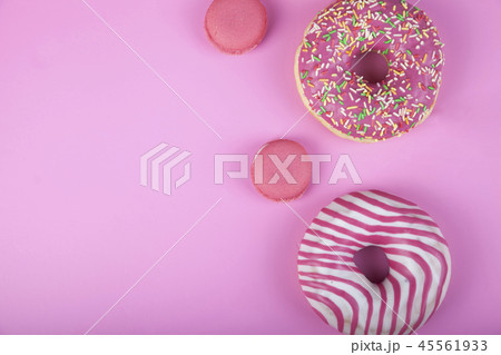 Donuts and macaroons on a pink background. Donuts and macaroons on a pink background. 45561933