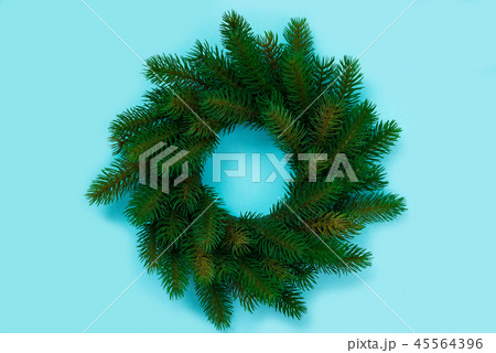 Winter and Christmas wreath with fir isolated on blue background. Top view 45564396