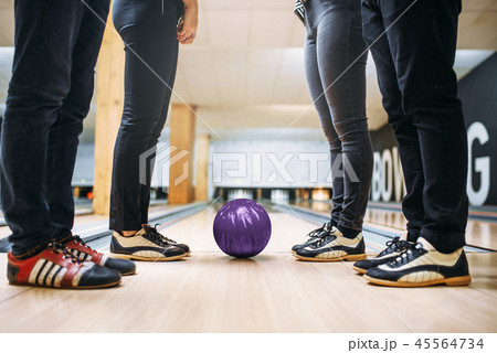 Bowling team, feet in house shoes and ball on lane Bowling team, feet in house shoes and ball on lane 45564734
