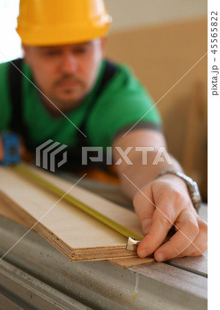 Handsome worker measuring. Manual 45565822