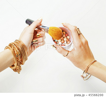 woman hands with golden manicure and many rings holding brushes, woman hands with golden manicure and many rings holding brushes, 45566200