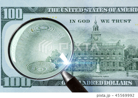 100 US Dollar under magnifying glass 100 US Dollar under magnifying glass 45569992