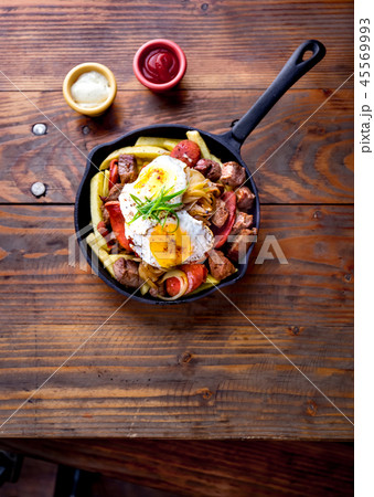CHILEAN FOOD. CHORRILLANA - french fries topped with beef sliced, tipical sausages chorrisos, fried CHILEAN FOOD. CHORRILLANA - french fries topped with beef sliced, tipical sausages chorrisos, fried 45569993