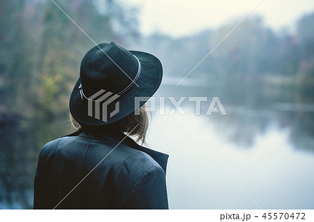 The girl looks at the river 45570472