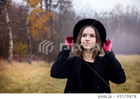 Girl straightens her hat Girl straightens her hat 45570878