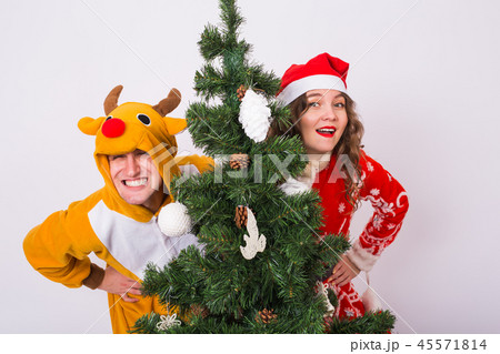 People, fun and holidays concept - funny woman and man in costumes of deer and santa on white 45571814