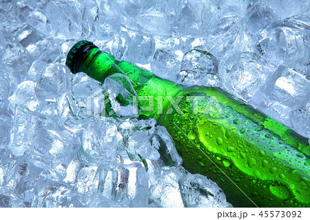 Bottle of beer in ice cubes.Closeup.Green bottle. Bottle of beer in ice cubes.Closeup.Green bottle. 45573092