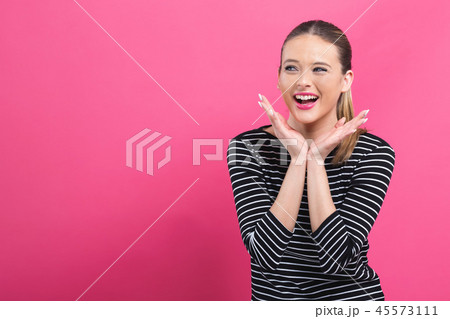 Surprised young woman posing 45573111