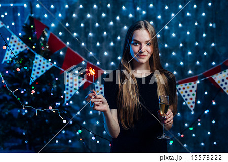 Girl celebrating new years eve with bengal light. Christmas Girl celebrating new years eve with bengal light. Christmas 45573222