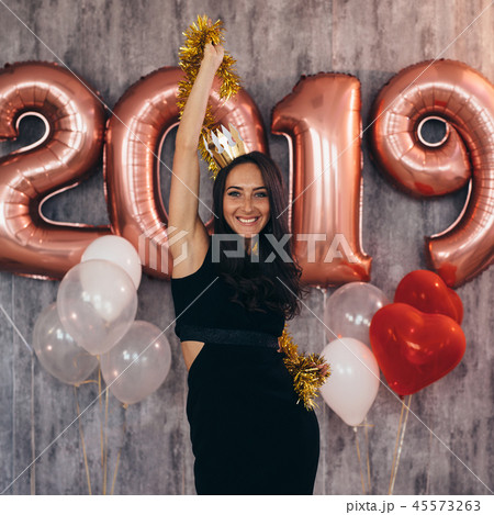 Woman holding balloons looking at camera. Celebration holiday new year Woman holding balloons looking at camera. Celebration holiday new year 45573263