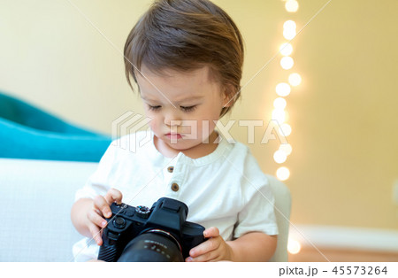 Toddler boy with a professional camera 45573264