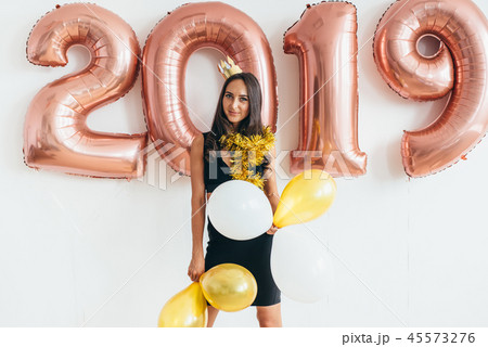 Woman holding balloons looking at camera. Celebration holiday new year Woman holding balloons looking at camera. Celebration holiday new year 45573276