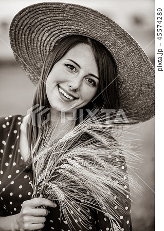 farm girl holding wheat ears on a field farm girl holding wheat ears on a field 45574289