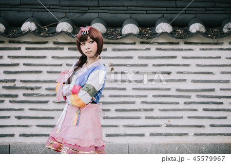 Portrait of Hanbok costume young woman looking and smile in korean park Portrait of Hanbok costume young woman looking and smile in korean park 45579967