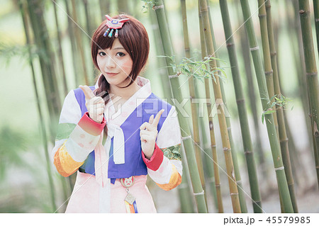 Portrait of Hanbok costume young woman looking and smile in korean park 45579985
