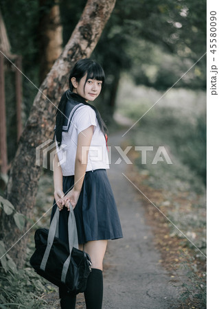 Portrait of asian japanese school girl costume looking at park outdoor film vintage style 45580090