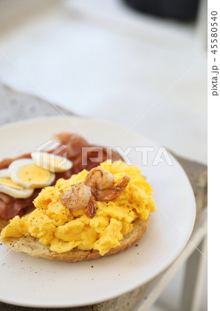 breakfast with scrambled eggs, fried potatoes bacon and shrimp breakfast with scrambled eggs, fried potatoes bacon and shrimp 45580540