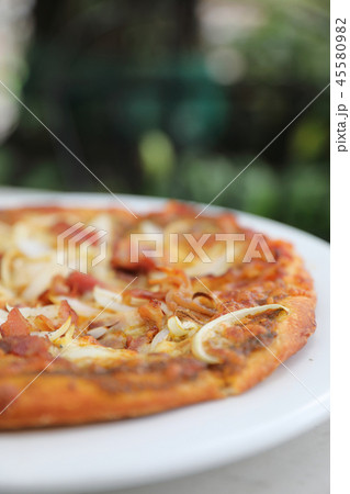 Pizza with crispy bacon onion on outdoor table Pizza with crispy bacon onion on outdoor table 45580982