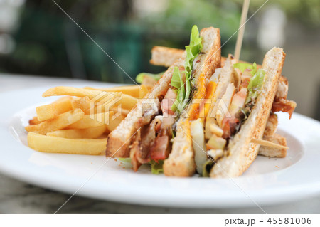 Club sandwich , Sandwich with egg bacon chicken tomato with fried outdoor restaurant background Club sandwich , Sandwich with egg bacon chicken tomato with fried outdoor restaurant background 45581006