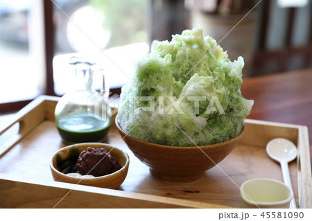 Delicious Japanese sweet shaved ice green tea on wooden table in japanese cafe Delicious Japanese sweet shaved ice green tea on wooden table in japanese cafe 45581090