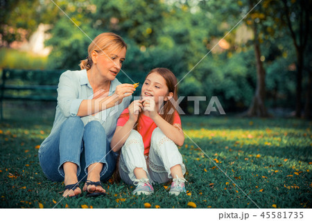 Happy mother and little kid daughter in park. Happy mother and little kid daughter in park. 45581735