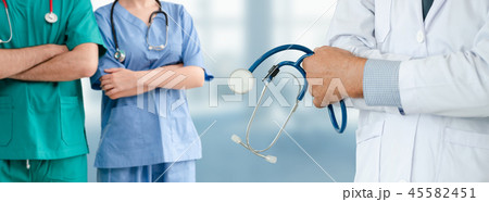 Doctor working in hospital with other doctors. Doctor working in hospital with other doctors. 45582451