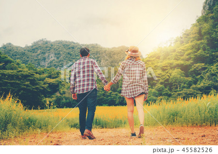 Happy couple take a romantic walk on the hills. Happy couple take a romantic walk on the hills. 45582526