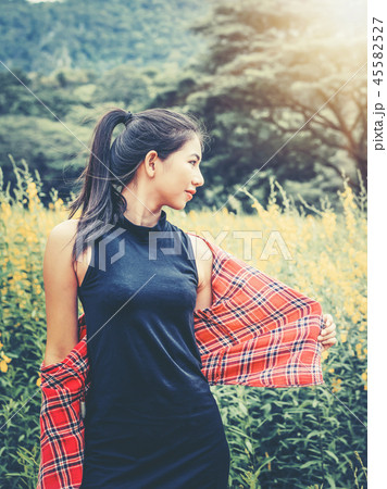 Happy woman in green field and mountain background Happy woman in green field and mountain background 45582527