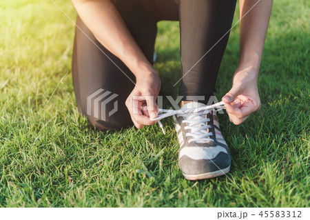 young asian woman prepare shoe before running 45583312