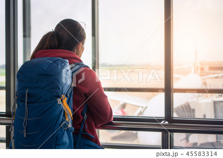 woman standing at the window in hall airplane 45583314