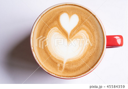 cup of coffee with a heart shaped bubble rests cup of coffee with a heart shaped bubble rests 45584359