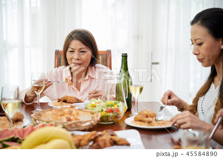 Senior woman eating delicious food 45584890