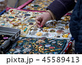 Woman choose the antique brooch at the flea market 45589413
