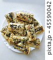 Cutted lavash pieces with vegetables on the plate. Burek with spinach and cheese and black cumin 45590042
