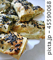 Cutted lavash pieces with vegetables. Burek with spinach and cheese and black cumin. Yufka 45590068