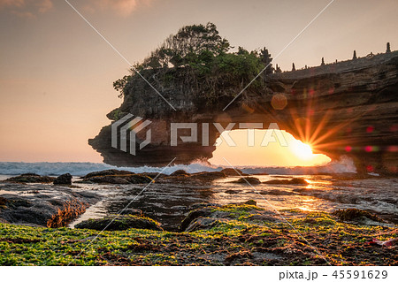 Sunshine through of rocky cliff on seashore 45591629