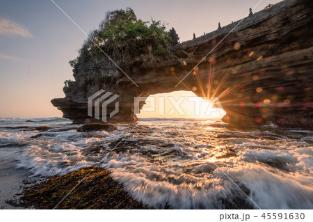 Sunshine through of rocky cliff on seashore Sunshine through of rocky cliff on seashore 45591630