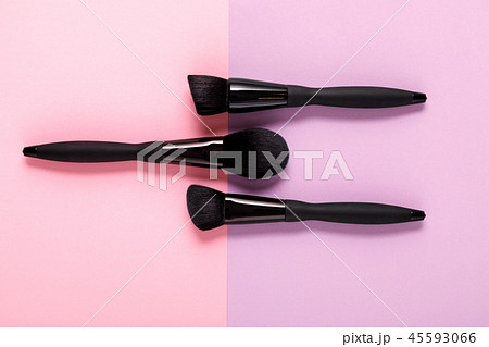 makeup brushes on pastel paper pink background 45593066