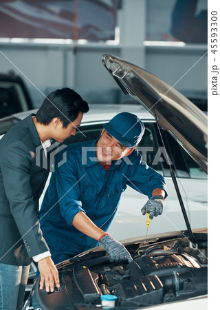 Car owner and mechanic at workshop 45593300