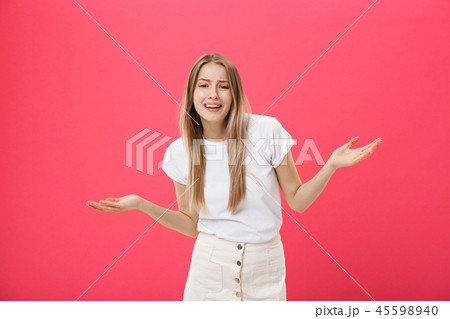 Displeased female model with freckled skin, raises eyebrows and frowns face, makes refusal gesture Displeased female model with freckled skin, raises eyebrows and frowns face, makes refusal gesture 45598940