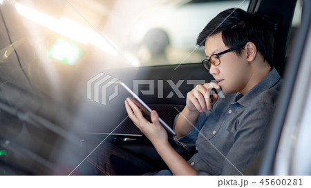 Asian businessman using tablet sitting in the car 45600281