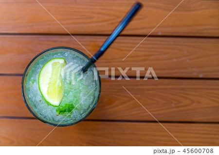 Mojito cocktail with lime and mint in glass on wooden table 45600708