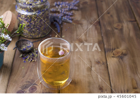 Tea in a glass with lavender on a wooden background. Hot drinks for health. 45601045