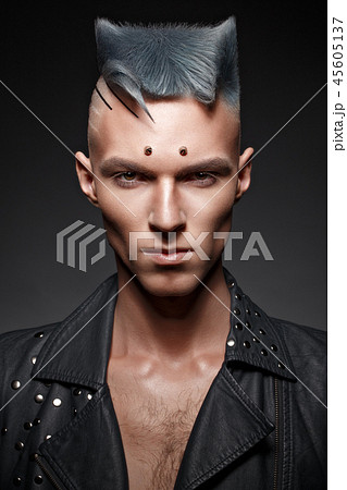 Young man with blue hair and creative makeup and hair. Young man with blue hair and creative makeup and hair. 45605137
