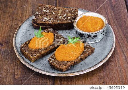 Vegetable caviar from pumpkin and zucchini on wooden table 45605359