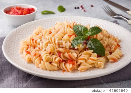 Spiral pasta mixed with cherry tomatoes and tomato 45605649