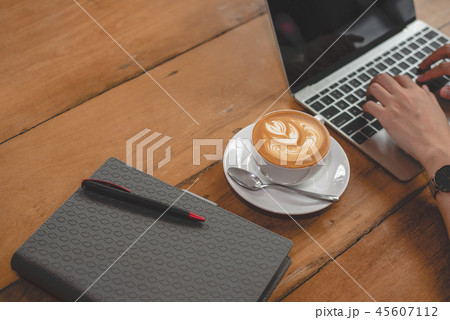 Close up of coffee cup with notebook Close up of coffee cup with notebook 45607112